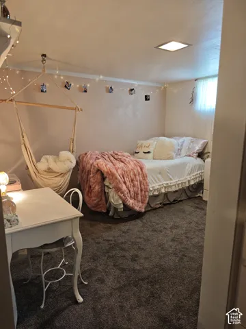 Bedroom featuring dark wall-to-wall carpeting, recessed ceiling lighting, and a high-set slider window