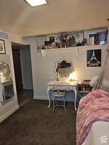 Wall-to-wall carpeting, recessed ceiling lighting, and a built-in wall shelf