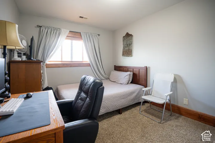 Carpeted flooring, wood trim window casing, and wood trim baseboards