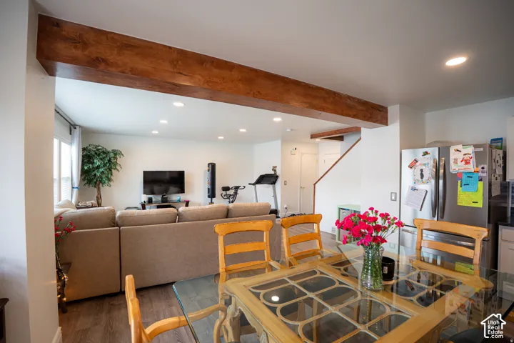 Exposed wood-finish structural beam, recessed lighting, and wood-finish flooring