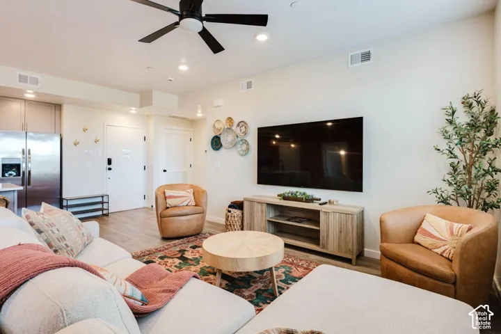 Open-concept interior featuring wood-finish flooring, recessed lighting, and a modern ceiling fan