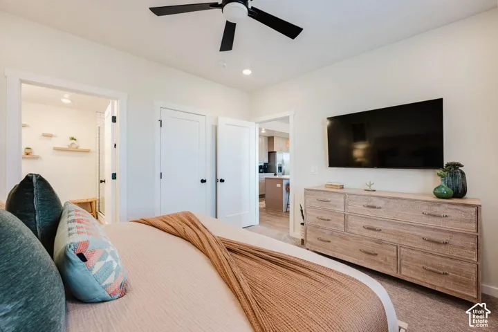 Neutral-toned room featuring a matte black ceiling fan, recessed lighting, and two-panel shaker-style interior doors with matte black hardware