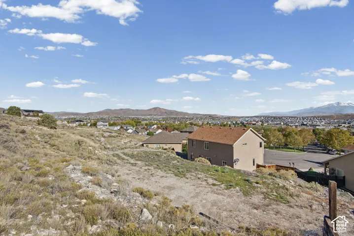 Expansive hillside parcel featuring native vegetation and a panoramic mountain backdrop