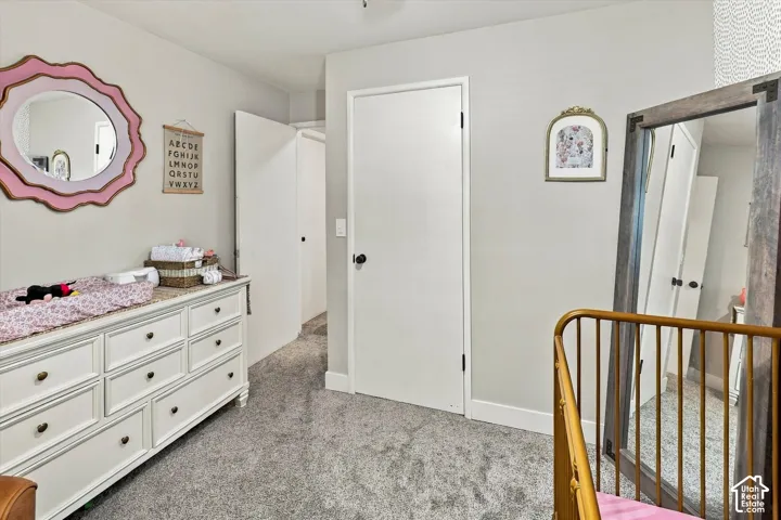 Interior space featuring neutral wall paint, wall-to-wall carpeting, and solid-core interior doors with dark hardware