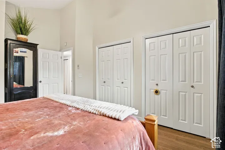 Vaulted ceilings, dual bifold closets with raised-panel doors, and wood-finish flooring