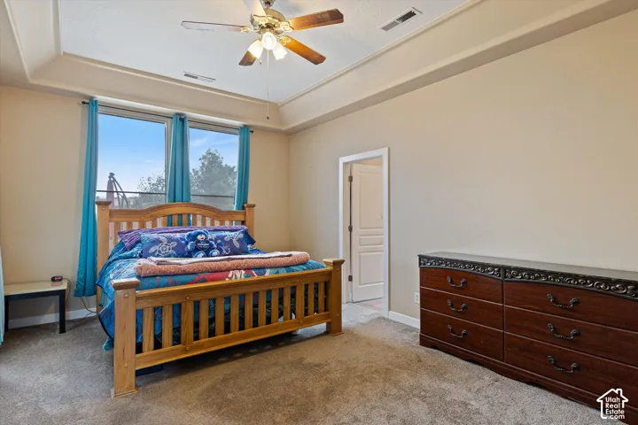 Tray ceiling with integrated lighting, dual window configuration, and three-panel interior door
