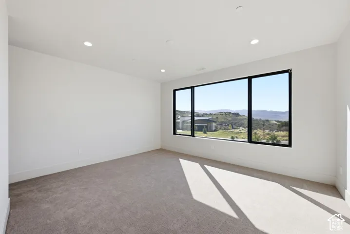 Spacious room featuring a panoramic window with broad mountain and valley views