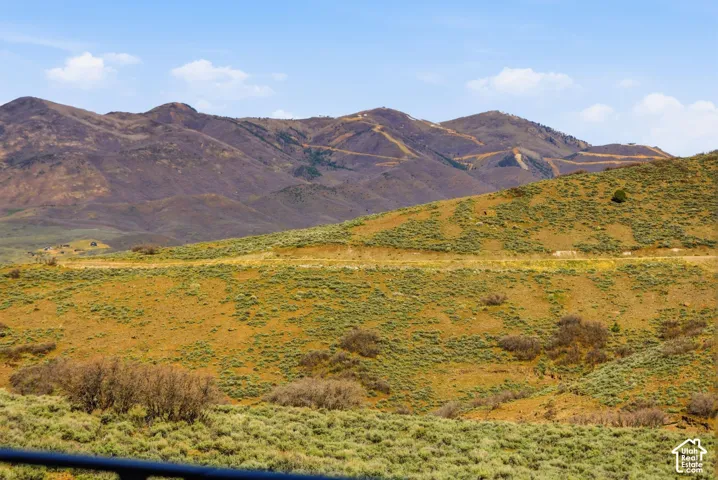 Expansive mountain terrain featuring rolling hills and distant peaks