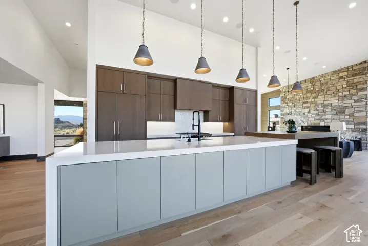 Modern kitchen featuring a large island with a light grey base and white countertop