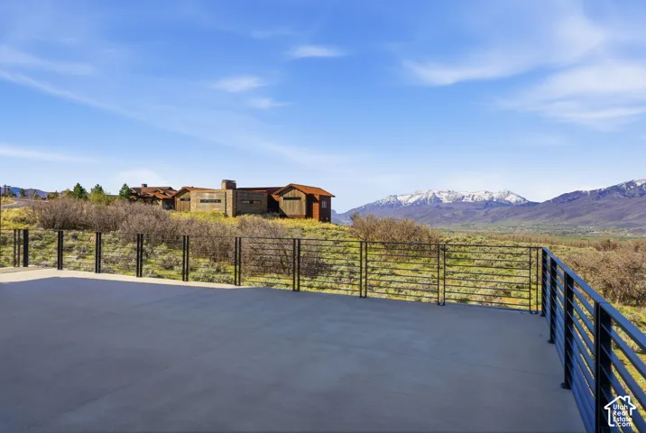 Expansive outdoor concrete patio with horizontal metal railing