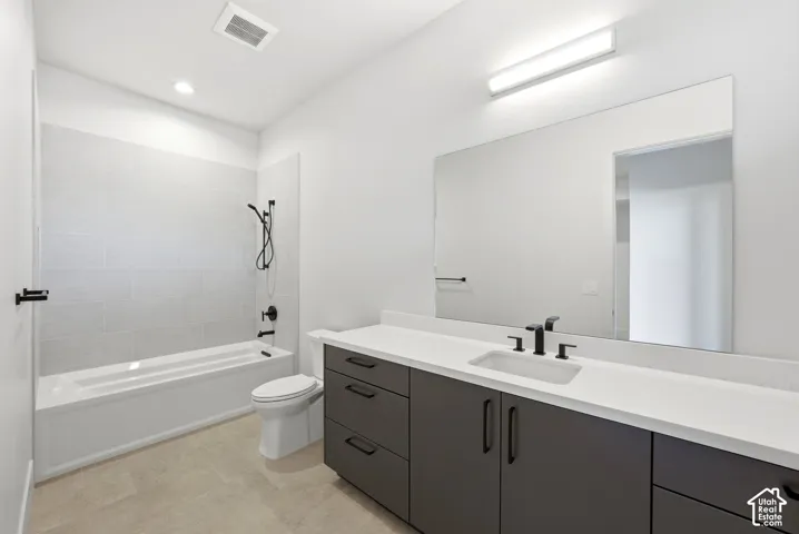Full bathroom featuring a single vanity with a white countertop and dark gray cabinetry, a rectangular undermount sink, and matte black fixtures