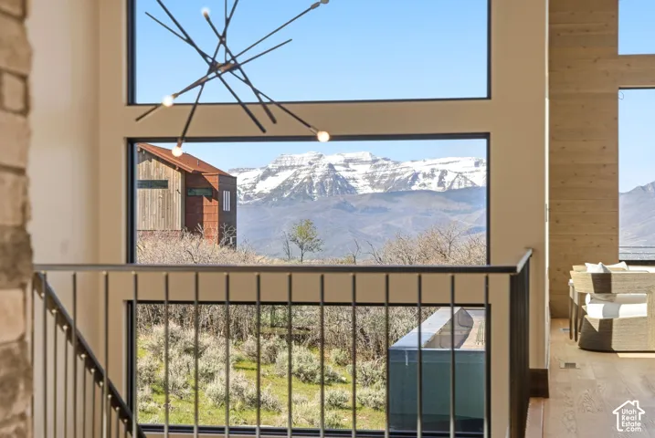Large picture windows frame a prominent mountain backdrop