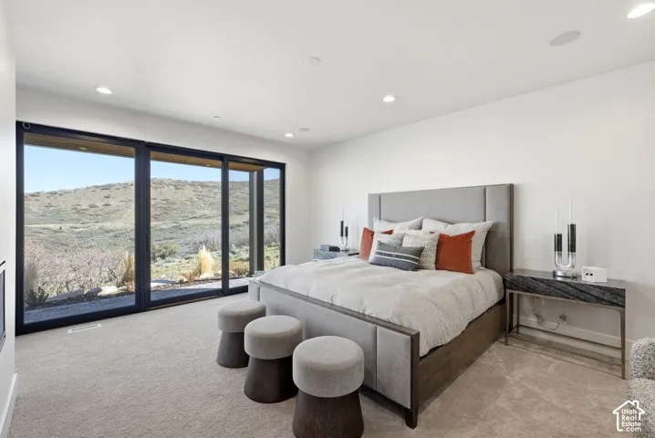 Floor-to-ceiling sliding glass doors showcase the surrounding landscape