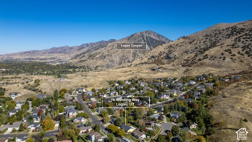 Aerial perspective of Logan, Utah, featuring prominent mountain topography and expansive canyon terrain