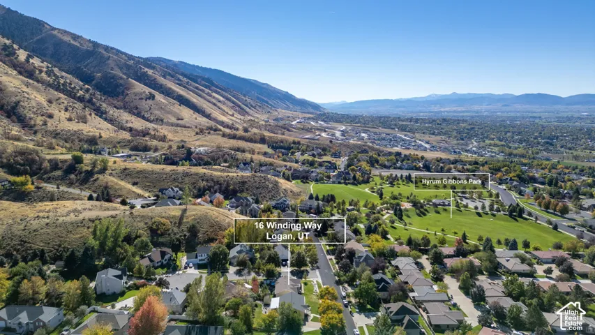 Aerial perspective featuring a hillside location, proximity to Hyrum Gibbons Park, and expansive mountain terrain
