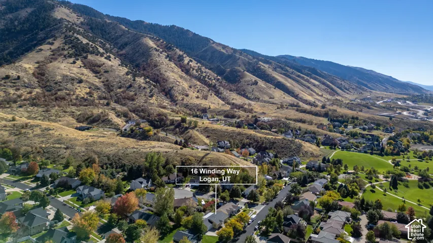 Aerial perspective featuring proximity to mountain terrain, expansive hillside topography, and mature vegetation