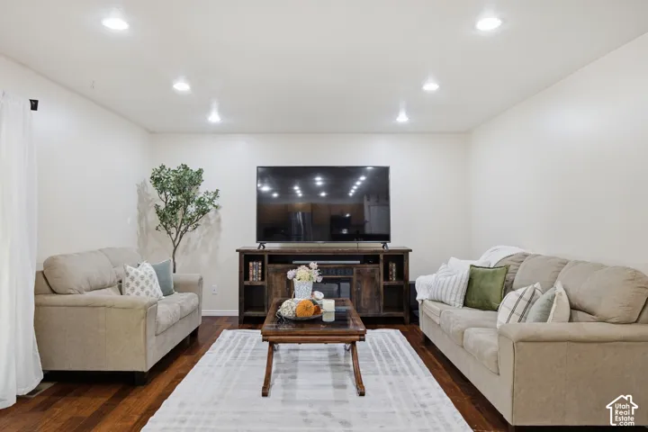 Interior space featuring dark-toned wood-finish flooring and recessed ceiling lighting