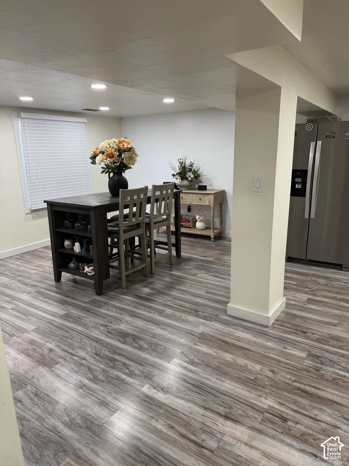 Wood-finish flooring, recessed lighting, and horizontal slatted blinds