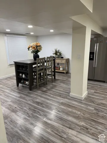 Wood-finish flooring, recessed lighting, and horizontal slatted blinds