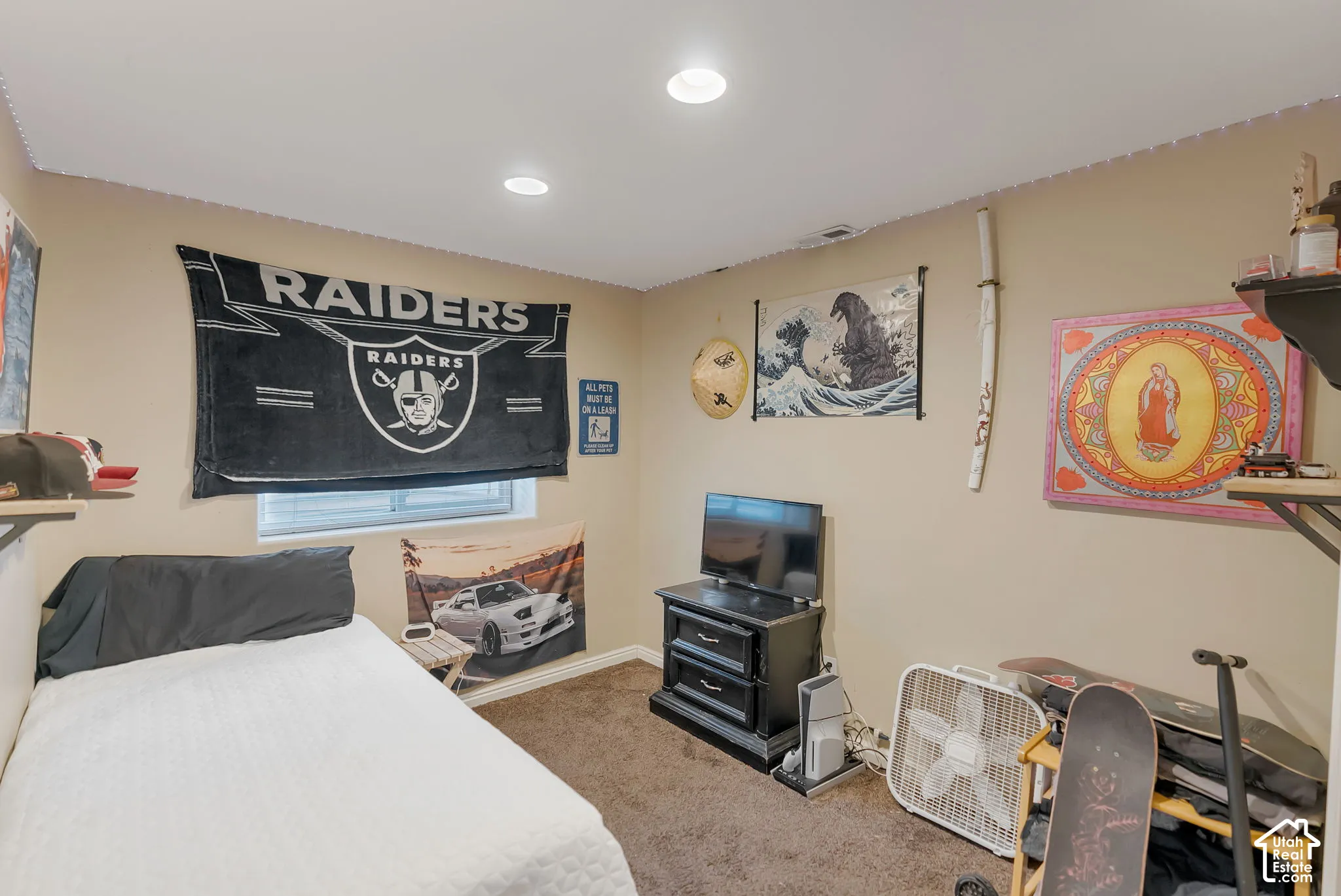 Neutral-toned room featuring recessed ceiling lighting, carpeted flooring, and a single window with blinds