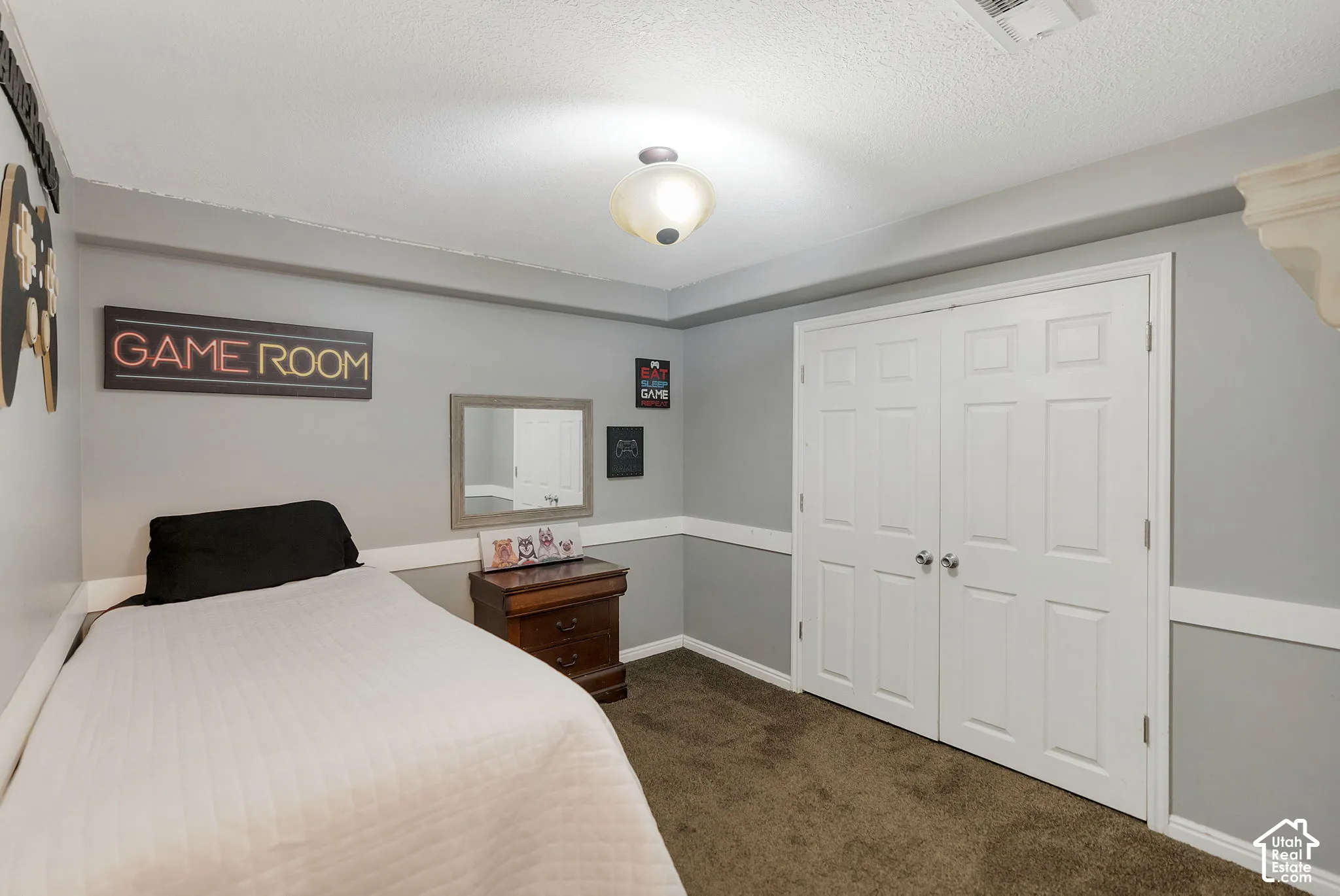 Interior room featuring neutral wall color, white chair rail molding, wall-to-wall carpeting, and double-door closet with chrome hardware