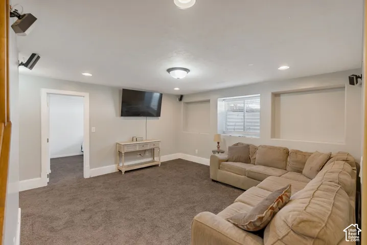 Recessed wall niches, ceiling-mounted speakers, recessed lighting, and wall-to-wall carpeting