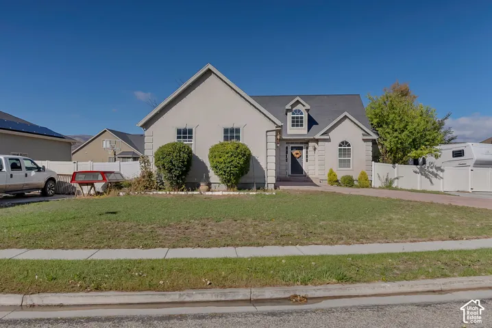 Stucco exterior featuring quoins, arched windows, a front-facing gable, and a decorative roof dormer