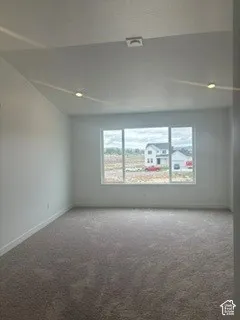 Primary bedroom upstairs with a vaulted ceiling