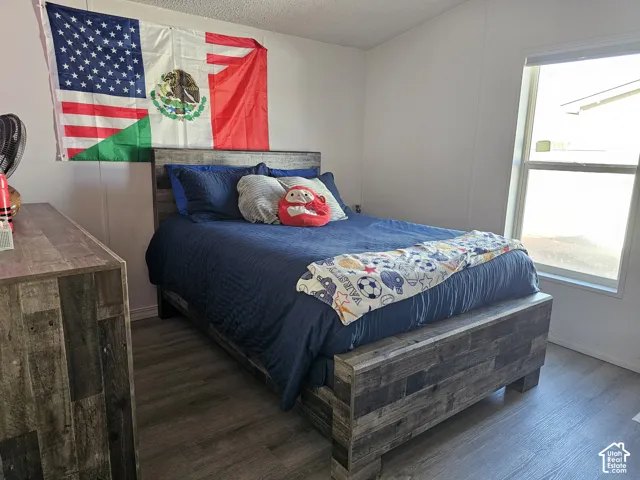 Neutral-toned wall finishes, wood-finish flooring, and a large dual-pane window