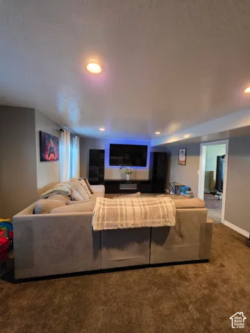 Recessed ceiling lighting, wall-to-wall carpeting, and a built-in media console