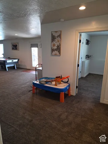 Interior space featuring wall-to-wall carpeting, recessed lighting, and a glass-paneled exterior door