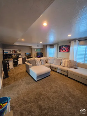 Interior room featuring wall-to-wall carpeting, recessed ceiling lighting, and built-in shelving