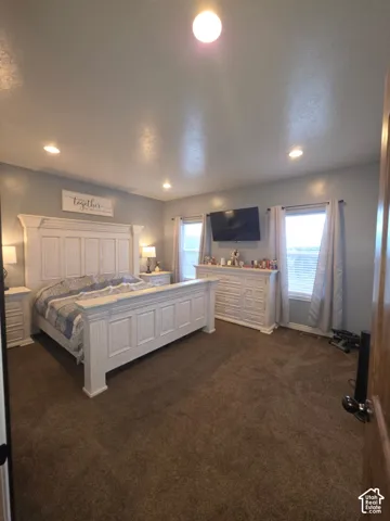Neutral wall palette with recessed lighting and two windows featuring horizontal blinds