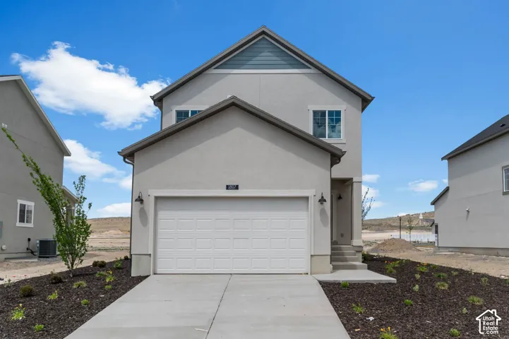 Two-story exterior featuring light-toned stucco siding, a concrete driveway, a single-car garage, and dark-toned gable roof shingles with decorative accent siding