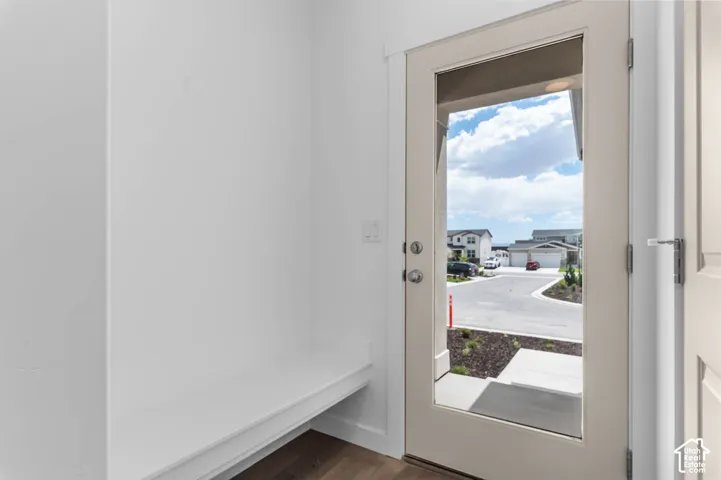 Entryway featuring a built-in bench, wood-finish flooring, and a single-light glass panel exterior door