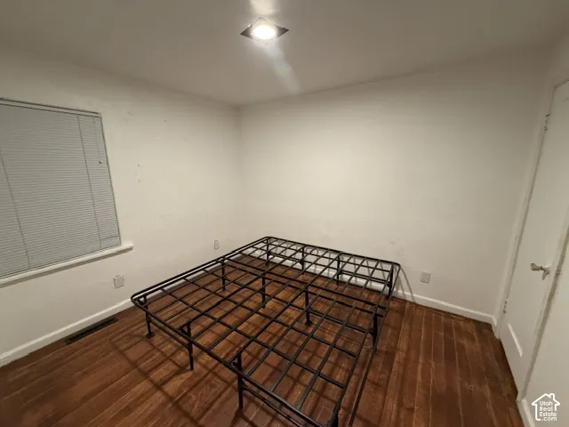 Wood-finish flooring, recessed ceiling lighting, and a single-panel interior door