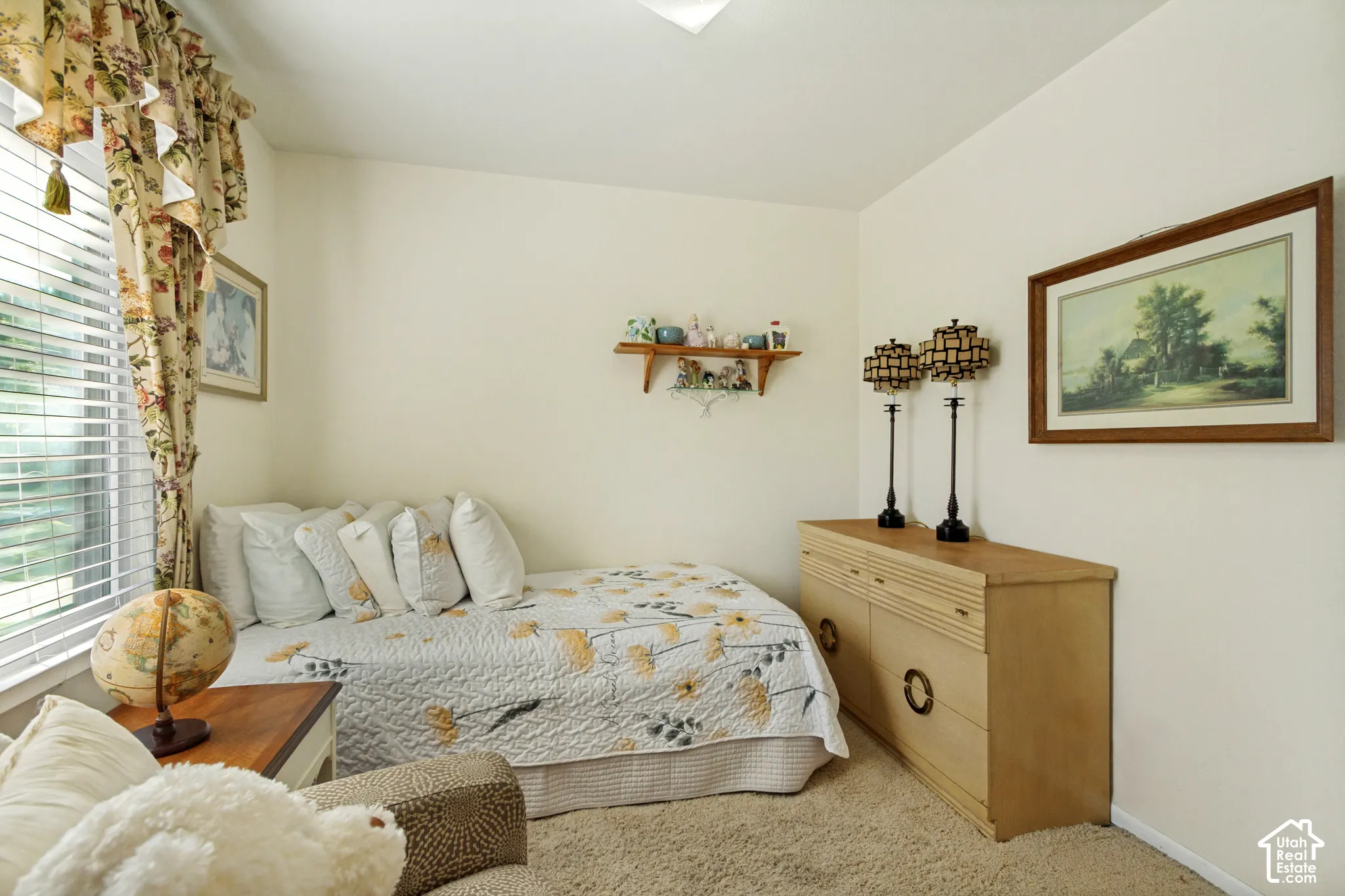 Wall-mounted wooden shelving, neutral carpeting, and horizontal slat window blinds