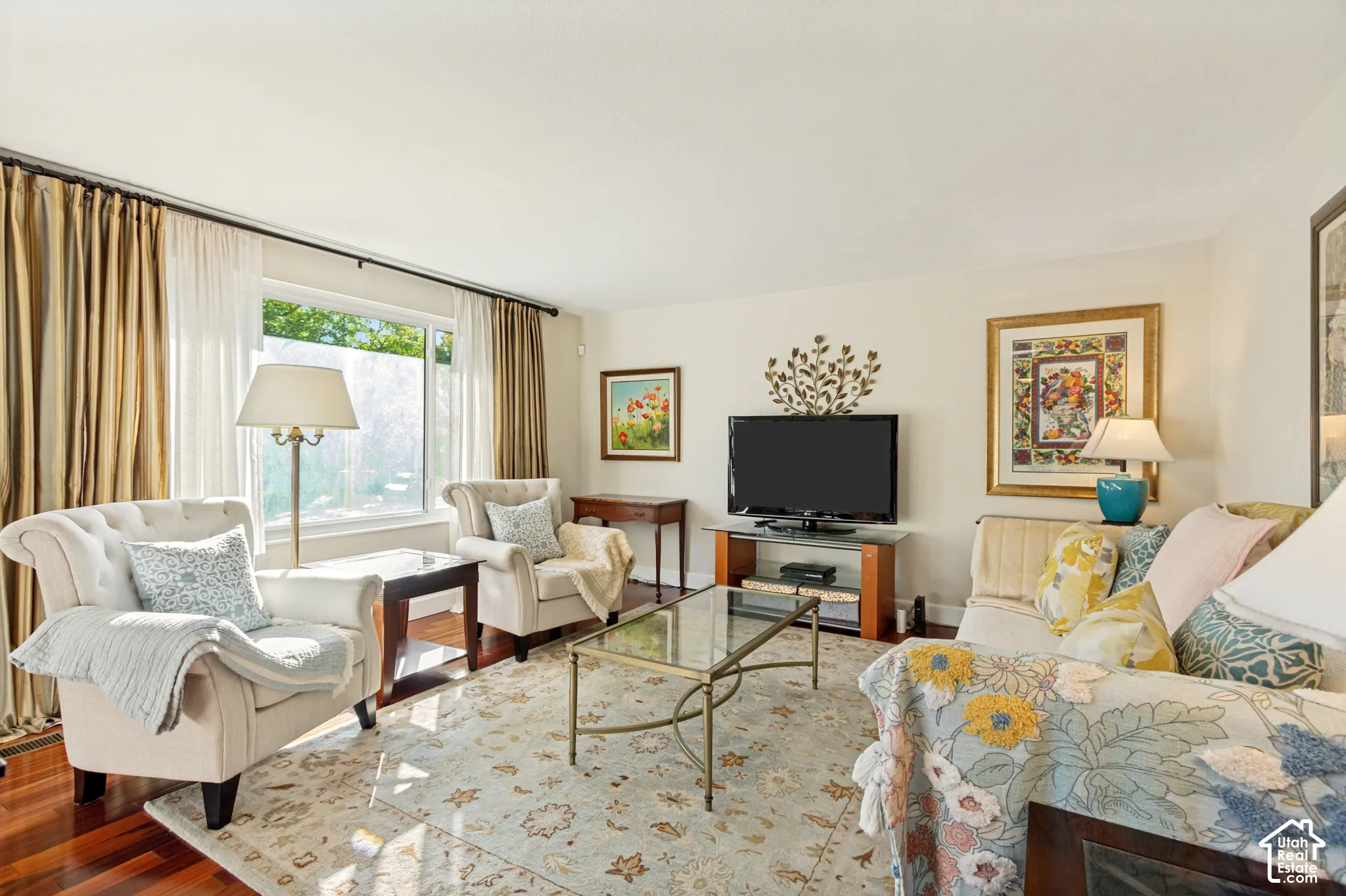 Living area featuring polished wood-finish flooring and a large picture window