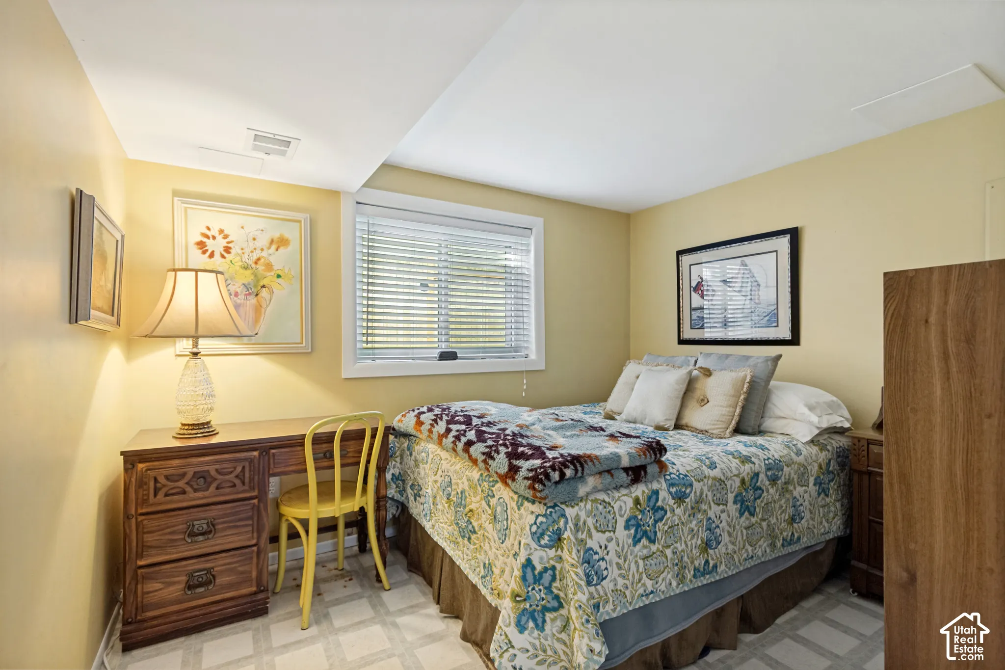 Room featuring neutral-toned walls, tile flooring, and a window with horizontal blinds