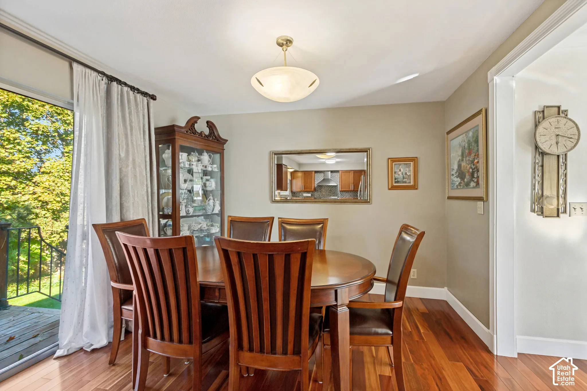 Dining area featuring wood-finish flooring, glass sliding door, and neutral wall paint