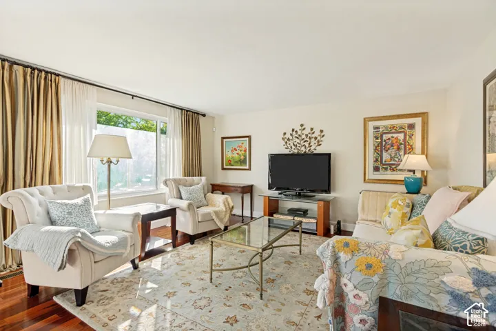 Living area featuring polished wood-finish flooring and a large picture window