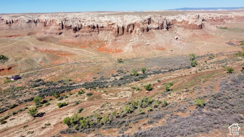 Expansive desert acreage featuring natural rock formations, native vegetation, and mature trees
