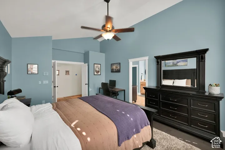 Vaulted ceiling featuring a central ceiling fan with integrated lighting