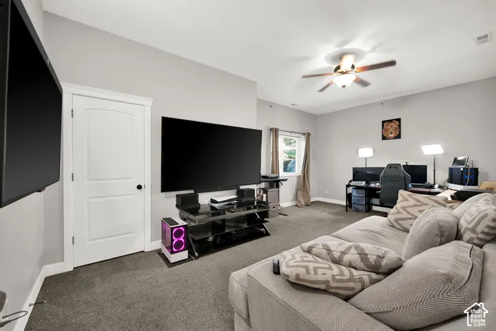 Room featuring neutral wall tones, wall-to-wall carpeting, a recessed window, and a multi-blade ceiling fan with an integrated light fixture