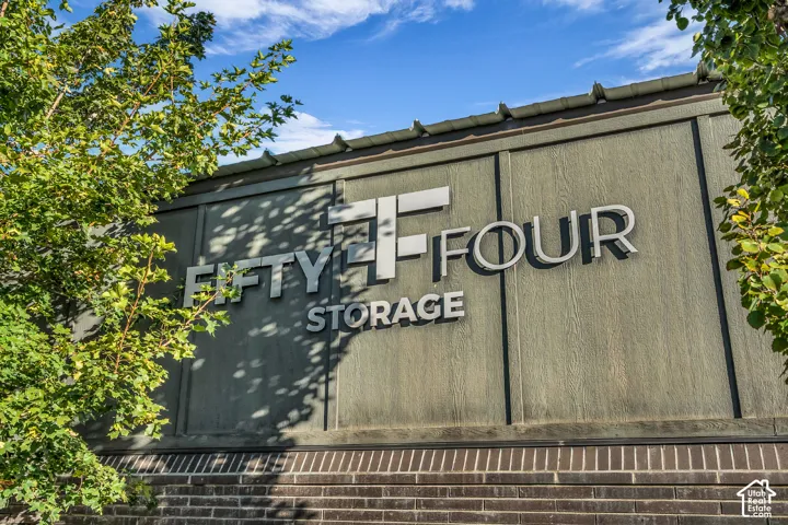 Textured siding exterior with brick masonry accents and dimensional metallic signage