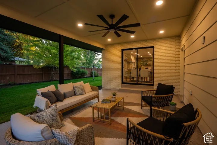 Covered patio featuring a painted brick exterior, recessed ceiling lighting, a matte black multi-blade ceiling fan, and sliding glass doors