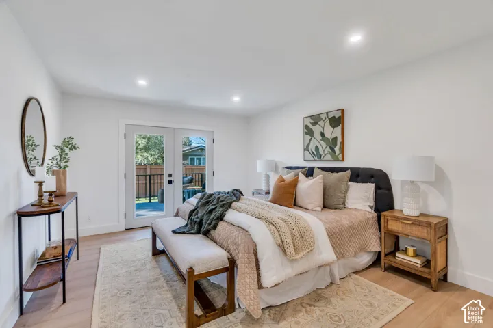 Neutral-toned interior featuring wood-finish flooring, recessed lighting, and double glass-paneled doors providing exterior access