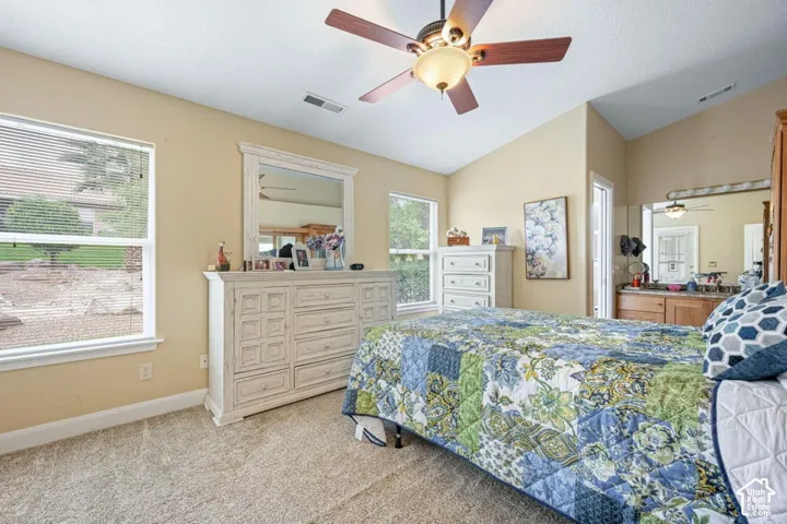 Vaulted ceilings featuring a multi-blade ceiling fan with integrated lighting and wall-to-wall carpeting