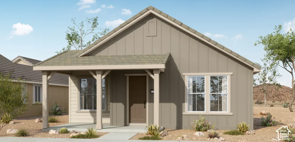 Single-story exterior featuring vertical siding, a covered front porch with timber-style posts, and a gable roof with neutral-toned shingles