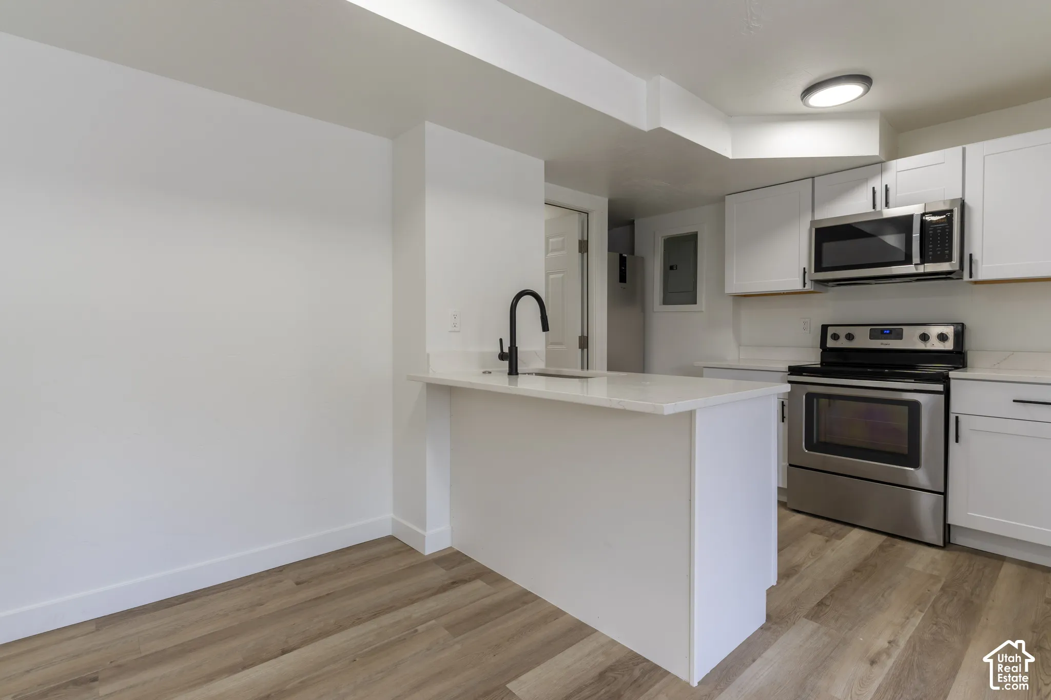 ADU kitchen with new cabinetry, quartz countertops, and stainless-steel appliances